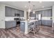 Stylish kitchen boasts gray cabinets, quartz countertops, stainless steel appliances, and an island with bar seating at 12650 Sunrise Dr, Noblesville, IN 46060