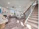 Spacious living room with a fireplace, open staircase, and seamless flow to the kitchen and dining areas at 12650 Sunrise Dr, Noblesville, IN 46060