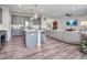 Open-concept living room featuring a modern kitchen with an island, a large sectional sofa, and a TV at 12650 Sunrise Dr, Noblesville, IN 46060
