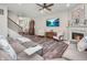 Cozy living room with a fireplace, comfortable seating, and a mounted TV above the mantel with views of a lake at 12650 Sunrise Dr, Noblesville, IN 46060