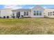 Wide shot of the backyard featuring a tidy lawn and patio at 12819 Bardolino Dr, Fishers, IN 46037