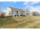 View of the rear exterior showing the siding, patio and manicured lawn at 12819 Bardolino Dr, Fishers, IN 46037