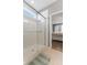 Shower in a bright bathroom with glass enclosure and view into the main bedroom at 12819 Bardolino Dr, Fishers, IN 46037