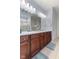 Bathroom featuring a double vanity with wood cabinetry, a large mirror, and a glass shower enclosure at 12819 Bardolino Dr, Fishers, IN 46037