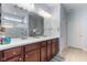 Bathroom with double vanity, ample lighting, and a glass-enclosed shower at 12819 Bardolino Dr, Fishers, IN 46037