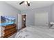 Cozy bedroom with a view of a television, an antique dresser, and a large closet at 12819 Bardolino Dr, Fishers, IN 46037