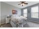 Comfortable bedroom featuring natural light, a ceiling fan, and neutral decor, providing a serene retreat at 12819 Bardolino Dr, Fishers, IN 46037