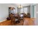 Traditional dining room features wooden table, chairs, china cabinet, chandelier, and hardwood floors at 12819 Bardolino Dr, Fishers, IN 46037