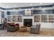 Cozy library room featuring a fireplace, sofas, and built-in bookshelves at 12819 Bardolino Dr, Fishers, IN 46037