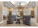 Inviting lounge area with stone fireplace, chandelier, and comfortable seating at 12819 Bardolino Dr, Fishers, IN 46037