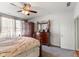 Well-lit main bedroom with a ceiling fan, wooden furniture, and a calming gray color scheme at 12819 Bardolino Dr, Fishers, IN 46037