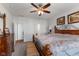 Elegant main bedroom showcasing a large bed, wooden furniture, and an open view to the ensuite bathroom at 12819 Bardolino Dr, Fishers, IN 46037