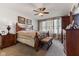 A spacious main bedroom featuring a ceiling fan, large bed, natural light, and traditional furnishings at 12819 Bardolino Dr, Fishers, IN 46037