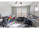 Bright office space featuring a ceiling fan, dual windows, and ample desk space at 12819 Bardolino Dr, Fishers, IN 46037