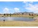 Scenic pond with mature trees, and green space offering a serene and relaxing environment at 12819 Bardolino Dr, Fishers, IN 46037