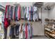 Organized walk-in closet features hanging rods, shelving, and dedicated shoe storage for optimal wardrobe management at 12819 Bardolino Dr, Fishers, IN 46037