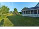 Manicured lawn leads to a screened in porch and playset for outdoor enjoyment at 13060 Wembly Cir, Carmel, IN 46033