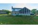 A well maintained backyard features a stone home, screened in porch and playset at 13060 Wembly Cir, Carmel, IN 46033