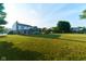 A large and spacious backyard with mature trees and an open lawn at 13060 Wembly Cir, Carmel, IN 46033