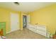 Yellow bedroom with carpet, white trim, and two white doors at 13060 Wembly Cir, Carmel, IN 46033