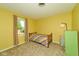 Yellow bedroom with carpet, bright window view, and green dresser at 13060 Wembly Cir, Carmel, IN 46033