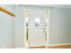Bright foyer with a white front door, coat rack and ample natural light at 13060 Wembly Cir, Carmel, IN 46033