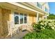 Charming front porch featuring rocking chairs, stone accents, and lush hydrangeas at 13060 Wembly Cir, Carmel, IN 46033