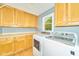 Well-equipped laundry room with storage cabinets, and a window for natural light at 13060 Wembly Cir, Carmel, IN 46033