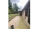 Wooden deck extends across the back of the brick home with a view of the back yard at 145 Goodnight Rd, Martinsville, IN 46151