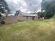 Large back yard featuring a brick home, storage shed and manicured lawn at 145 Goodnight Rd, Martinsville, IN 46151