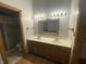 Bathroom with double vanity, decorative mirror, cabinet space, and tile flooring at 145 Goodnight Rd, Martinsville, IN 46151