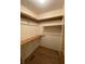 Walk-in closet with wood floor and built-in wooden shelving and hanging rack at 145 Goodnight Rd, Martinsville, IN 46151