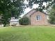 Well-kept brick home with mature trees shading the green, sloping lawn at 145 Goodnight Rd, Martinsville, IN 46151