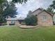 Charming brick home featuring a well-maintained lawn and detailed landscaping elements at 145 Goodnight Rd, Martinsville, IN 46151