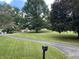 Front view of a home with lush lawn, mature trees, and a long driveway leading to the property at 145 Goodnight Rd, Martinsville, IN 46151