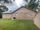 Back of a brick home with air conditioning and wooded view on a large lot at 145 Goodnight Rd, Martinsville, IN 46151