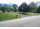 Exterior of a property with a sprawling front yard, paved driveway, mailbox, and mature trees at 145 Goodnight Rd, Martinsville, IN 46151