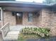 Charming front entrance with beautiful flowers leading to a front door with leaded glass at 145 Goodnight Rd, Martinsville, IN 46151