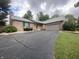 Brick single-story home with attached garage and a curved cracked asphalt driveway at 145 Goodnight Rd, Martinsville, IN 46151