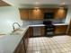 Well-lit kitchen with tile flooring, matching cabinets, and a stainless-steel dishwasher at 145 Goodnight Rd, Martinsville, IN 46151