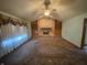 Bright living room with brick fireplace, built-in shelves, and large window offering natural light at 145 Goodnight Rd, Martinsville, IN 46151