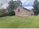 Side exterior of a brick house showing yard and well-manicured landscaping at 145 Goodnight Rd, Martinsville, IN 46151