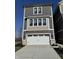 Charming two-story home featuring a white garage door, complementary gray siding, and ample natural light at 15407 Mystic Rock Dr, Carmel, IN 46033