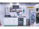 Finished basement features a bar with a beverage fridge, sink, shelving, and accent lighting at 1566 Dorset Dr, Avon, IN 46123