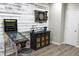 Basement game area features a dart board, pinball machine and an area for storage at 1566 Dorset Dr, Avon, IN 46123