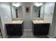 Bathroom featuring double sink vanity with dark cabinets, granite counters, and matching framed mirrors at 1566 Dorset Dr, Avon, IN 46123