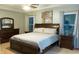 Comfortable bedroom with a tray ceiling, fan, and large windows with blinds at 1566 Dorset Dr, Avon, IN 46123