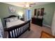 Green bedroom featuring carpet, ceiling fan, with cherry stained furniture and modern decor at 1566 Dorset Dr, Avon, IN 46123
