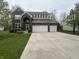 Well-maintained two-story brick home featuring an expansive driveway and basketball hoop at 1566 Dorset Dr, Avon, IN 46123