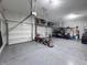 Spacious garage with epoxy flooring, storage solutions, and a vehicle at 1566 Dorset Dr, Avon, IN 46123